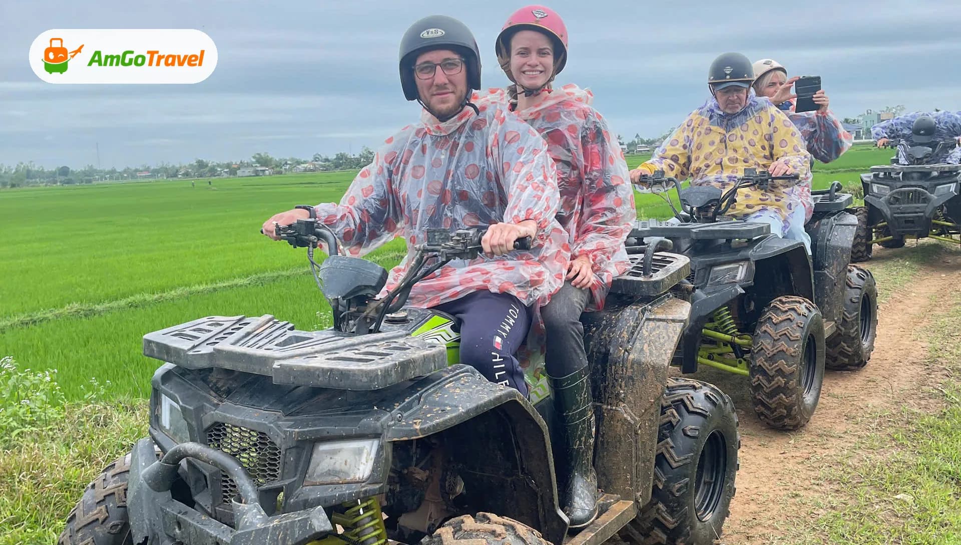 Tourists riding ATV quad bikes through rice fields