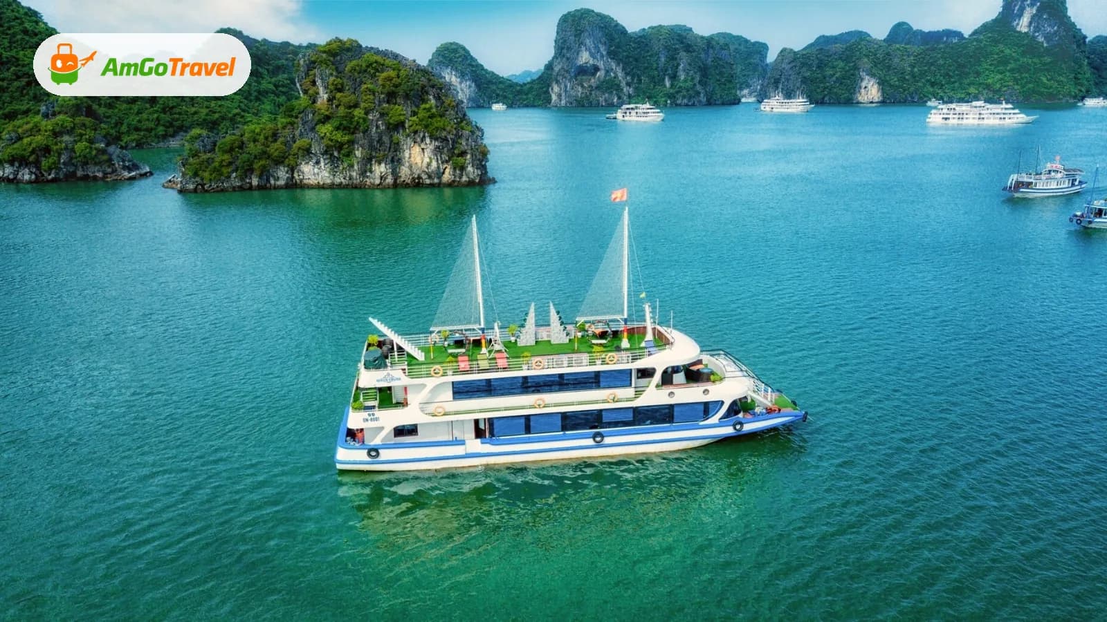 White cruise ship sailing among the islands of Ha Long Bay