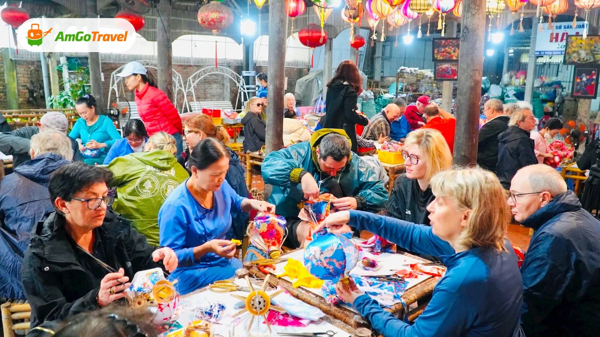 Travellers making silk lanterns at a workshop table