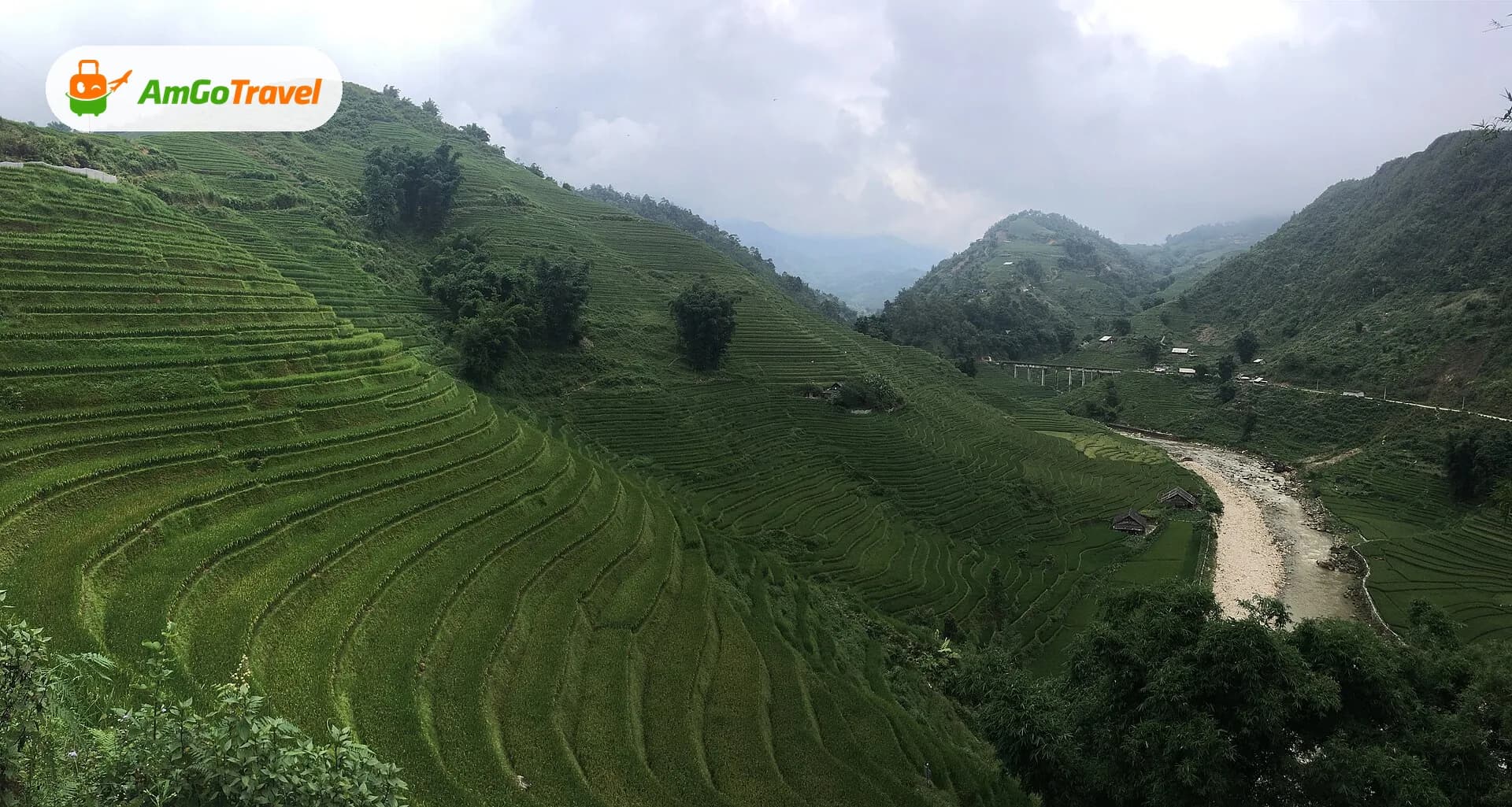 Green rice terraces sweeping down to the river in Muong Hoa valley