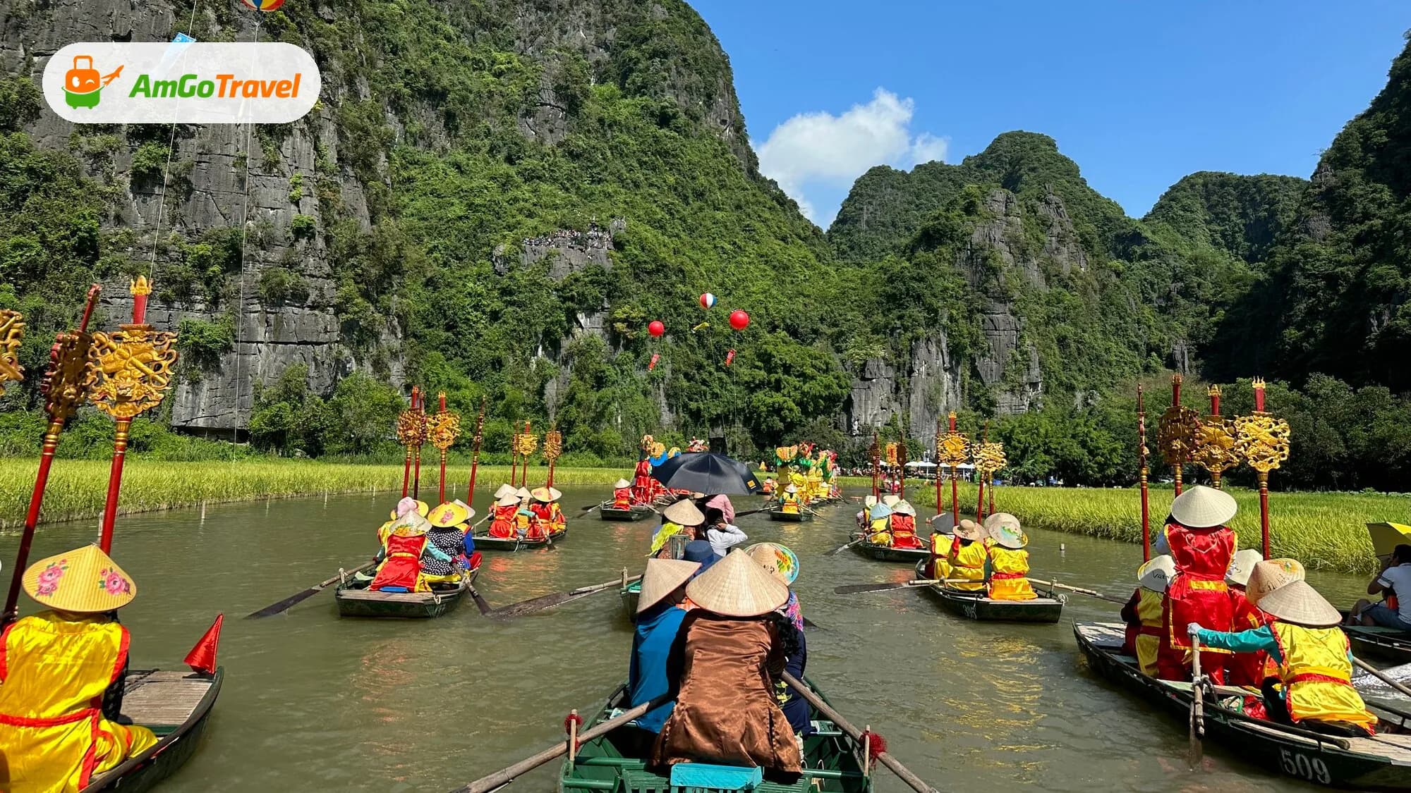 Rowing boats in festival procession among karsts